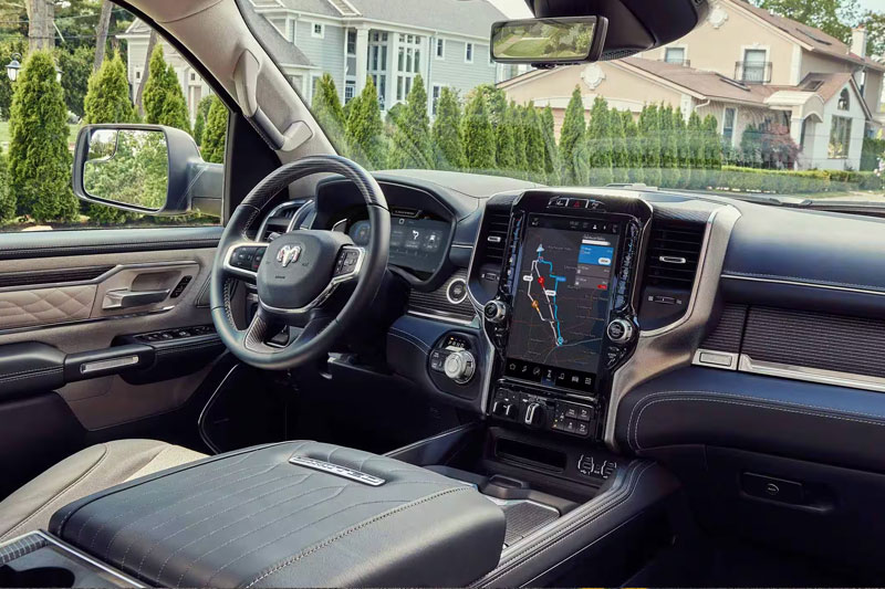 The interior of the 2023 Ram 1500 with the large Uconnect touchscreen displaying a navigation map.