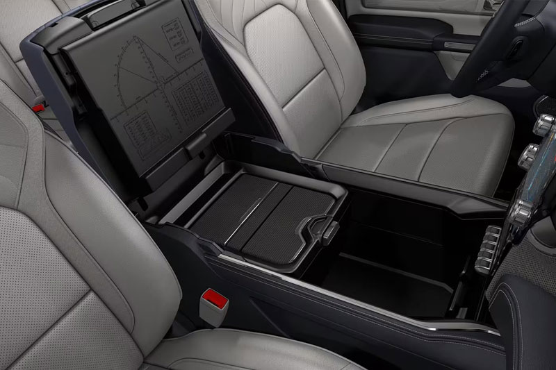 The front row seating in the 2023 Ram 1500 with the center console open to show the amount of storage it provides.