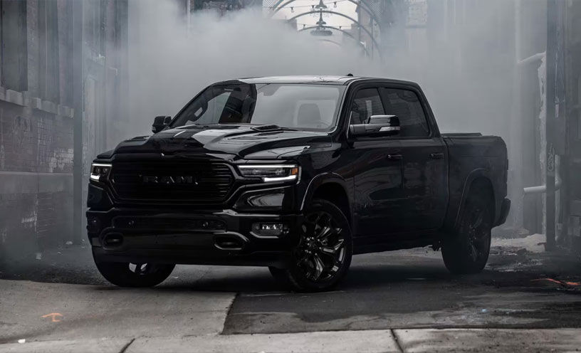 The 2023 Ram 1500 parked in a graffitied alleyway, surrounded by fog.